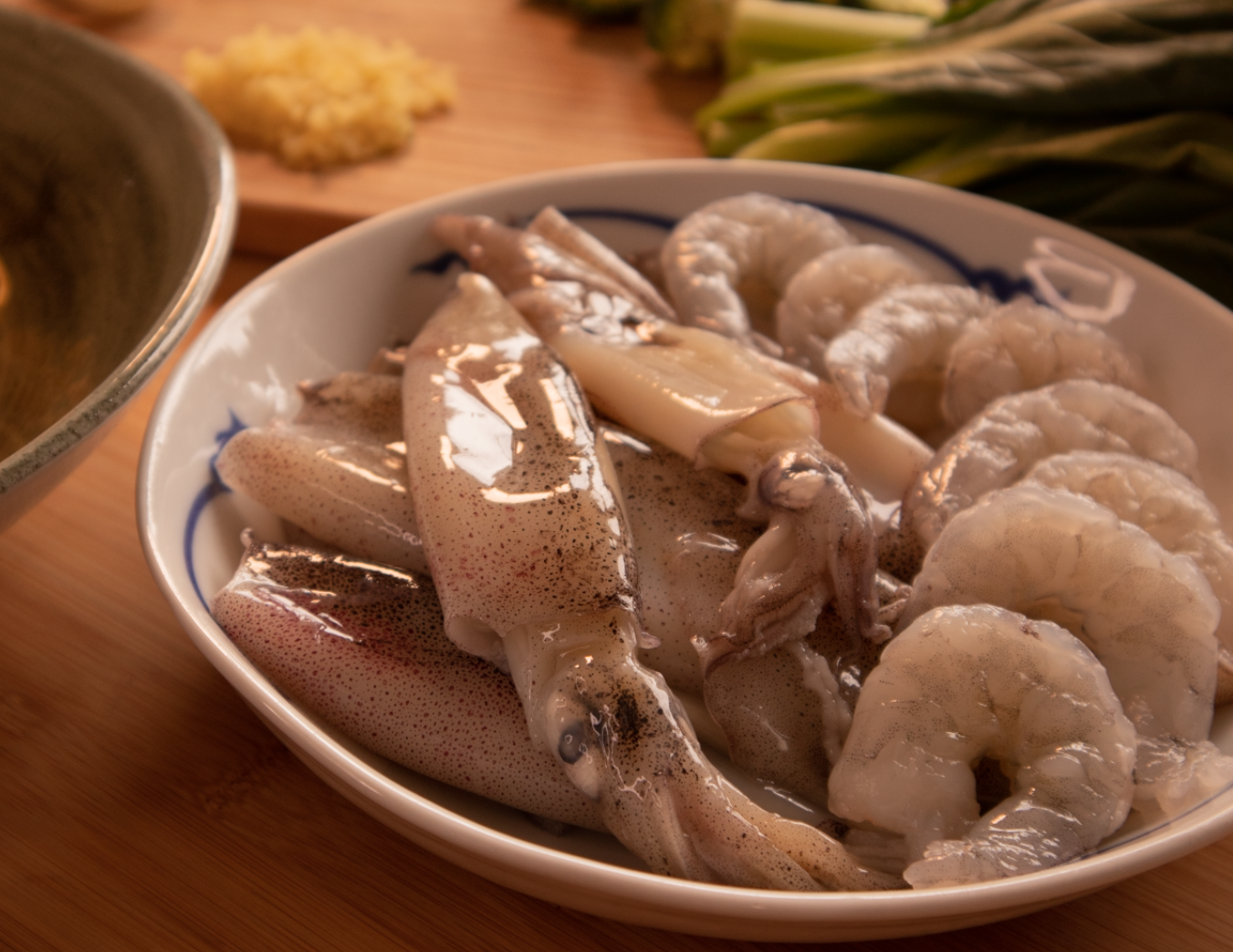 Raw baby squid and peeled king prawns